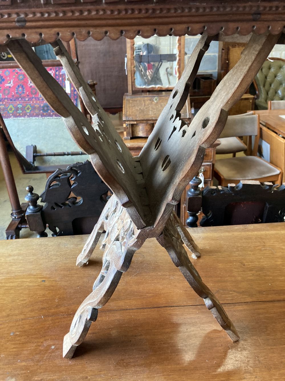 A WWI Sino-Burmese carved teak tray on folding stand,